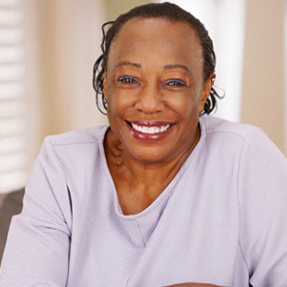 Smiling woman with dental implants in West Brookfield