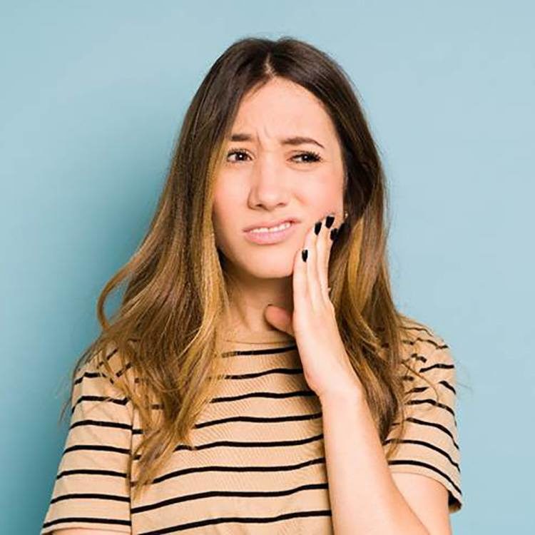 Closeup of woman experiencing toothache