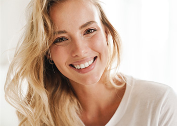 Closeup of woman with blonde hair smiling.